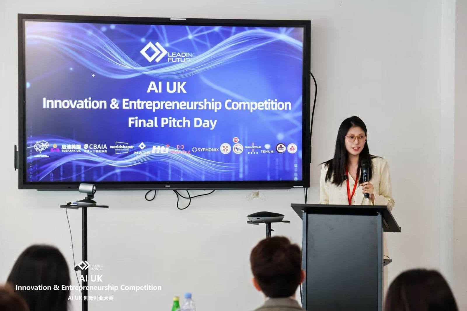 A speaker presenting at the lectern at the AI UK Innovation & Entrepreneurship Competition 2026