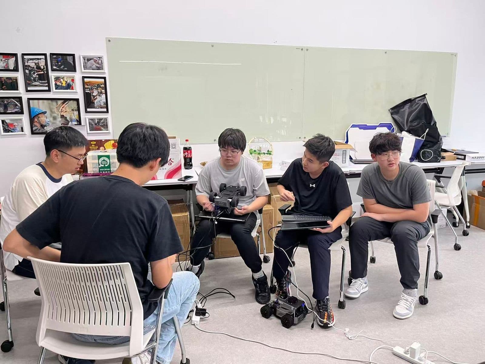 Students working together on a hands-on engineering task during the 2026 UCL Autonomous Driving Engineering Maker Challenge